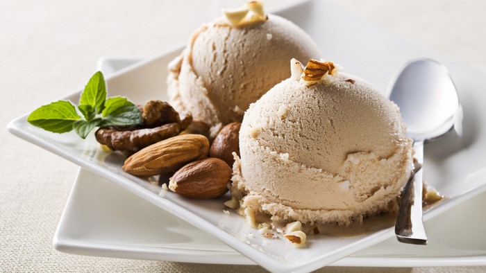 Ice cream scoops with nuts and mint leaves