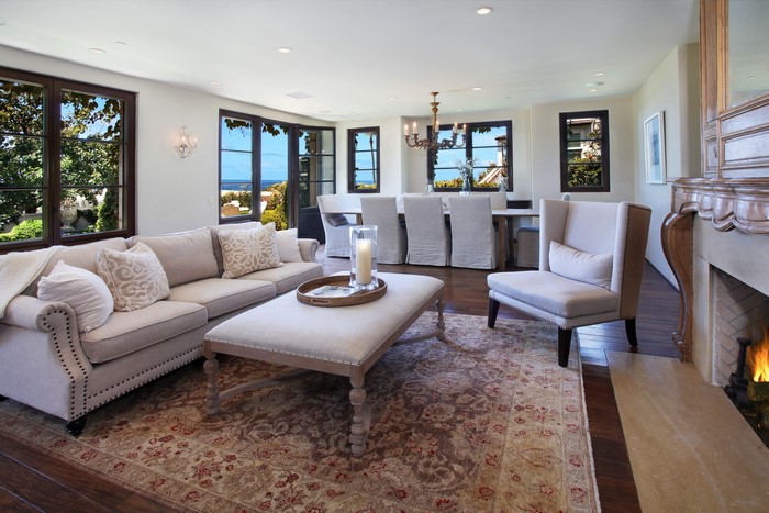 Living room with sofa, armchair, dining area, and fireplace
