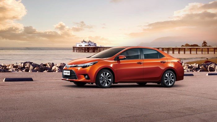 Orange Toyota Levin sedan parked by the beach