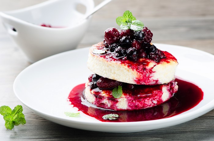 Stack of pancakes with berries and jam