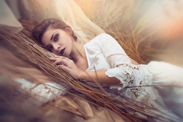 Woman with dark lipstick lying down