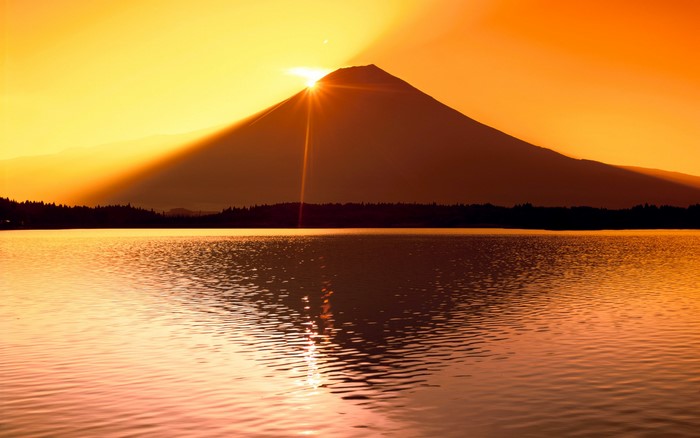 Mount Fuji at sunset over a lake