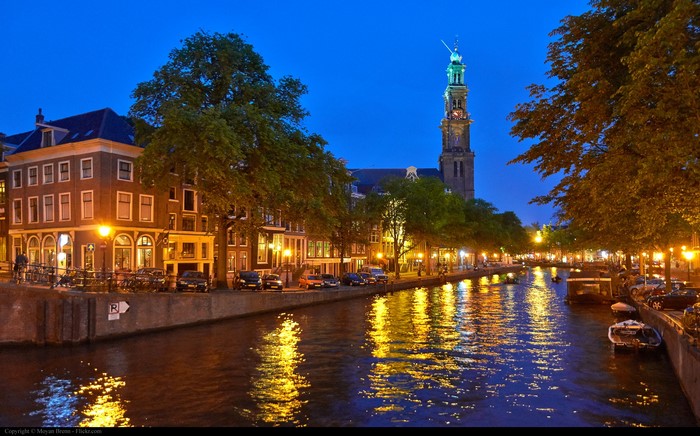 Amsterdam canal at night with Westerkerk tower