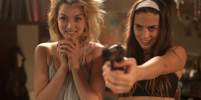 Blonde girl and brown-haired girl with gun