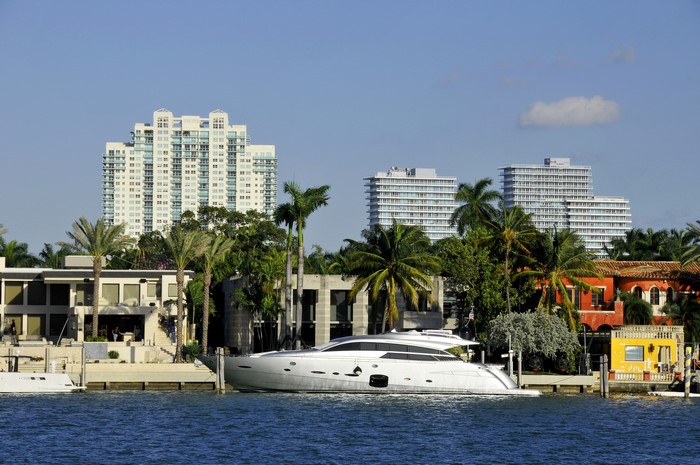 Yacht in Miami with Tall Buildings and Palm Trees