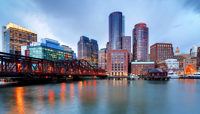Boston skyline with bridge and river at dusk
