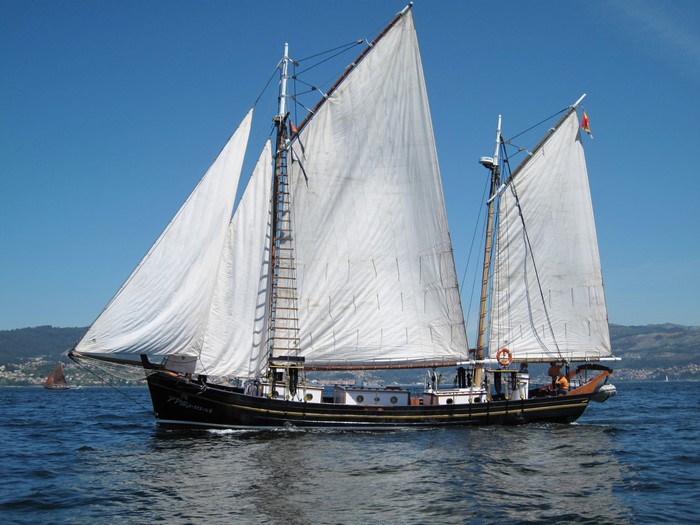 Sailing ship with white sails on the sea