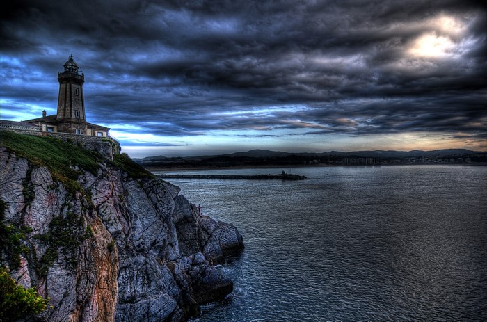 Lighthouse on a cliff overlooking the sea in Zeluan, Asturias, Spain