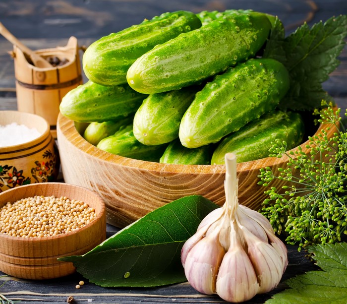 Pickling ingredients: cucumbers, garlic, dill, mustard seeds, and salt