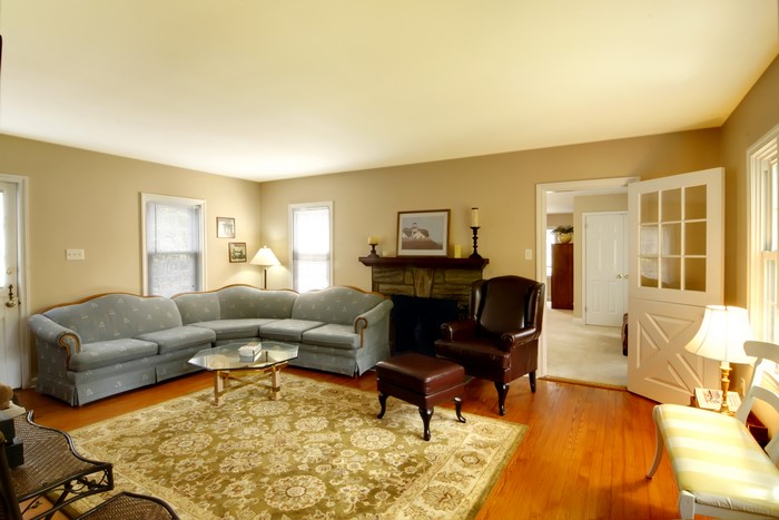 Living room with sectional sofa, armchair, and fireplace