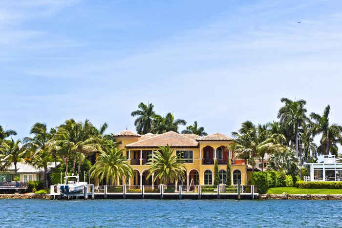 Mansion with palm trees on the water in Fort Myers Beach, Florida