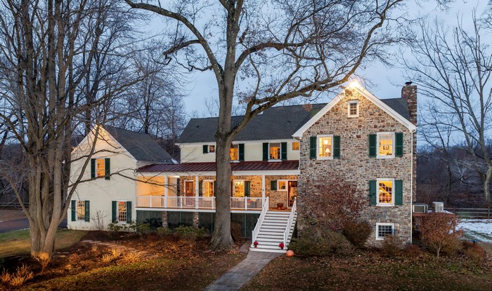 Stone and stucco house with porch and stairs