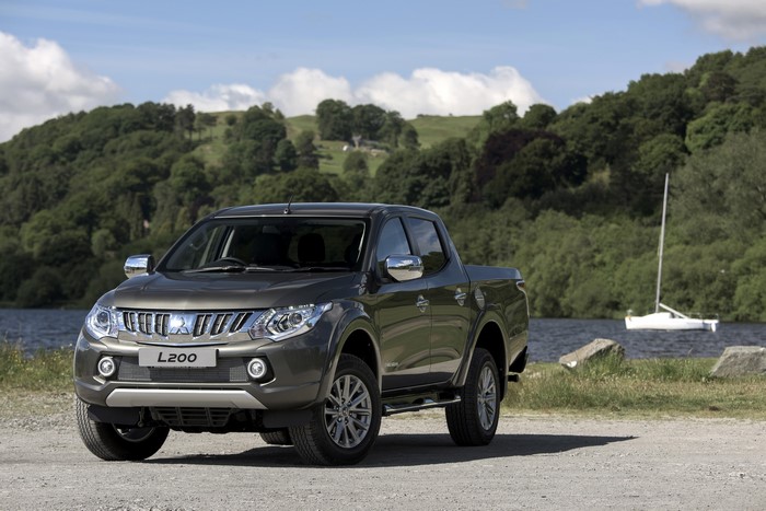 Grey Mitsubishi L200 pickup truck by a lake