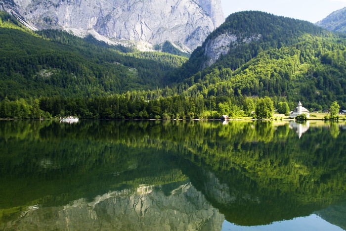 Lake reflection of mountains and forests in Austria