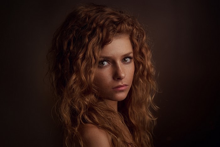 Woman with curly red hair and freckles