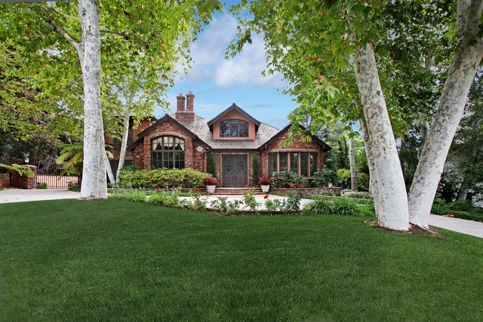 Brick house with large trees and lawn in San Juan Capistrano