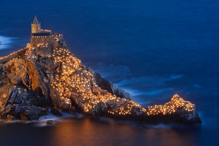 Church of St. Peter illuminated by candles at night
