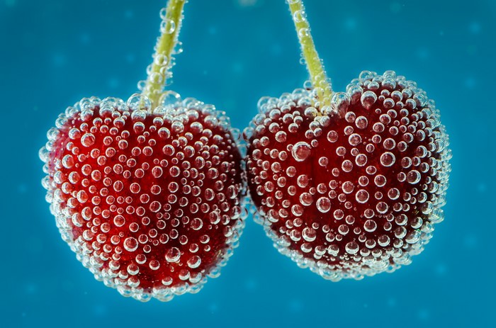 Two cherries in sparkling water