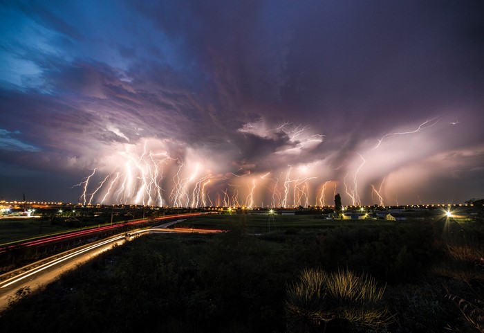 Lightning storm over a city at night