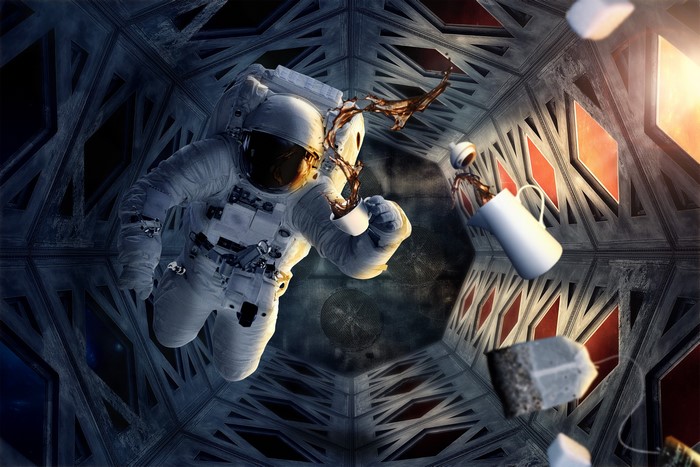 Astronaut drinking coffee in space station