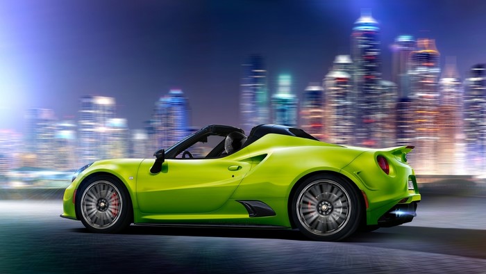 Alfa Romeo 4C Cabriolet driving in a city at night