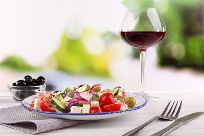 Greek salad with olives and red wine