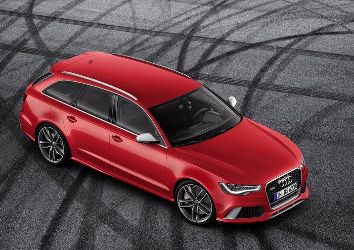 Red Audi RS6 Avant on asphalt with tire marks