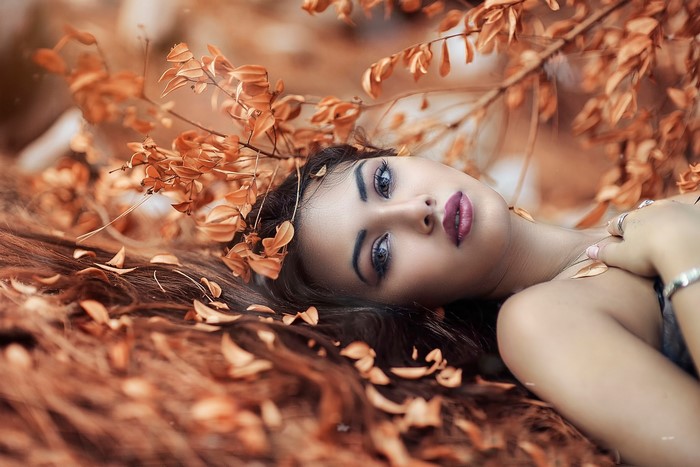 Woman with autumn leaves in hair