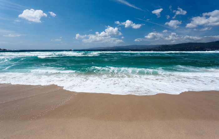 Beach with Waves and Mountains
