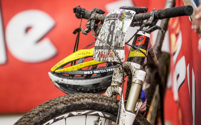 Muddy bicycle with helmet and race number 8