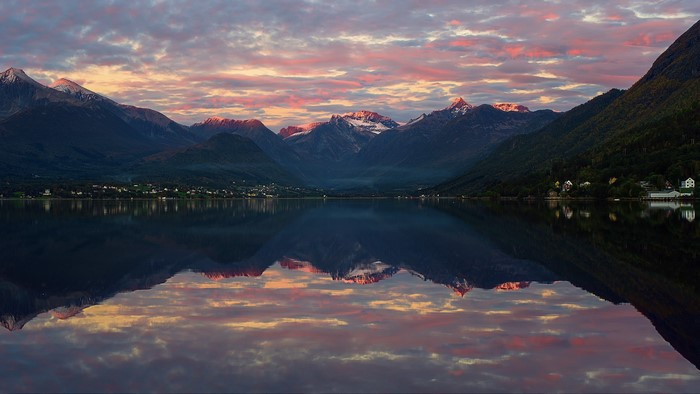 Mountains reflecting in a lake at sunset in Norway