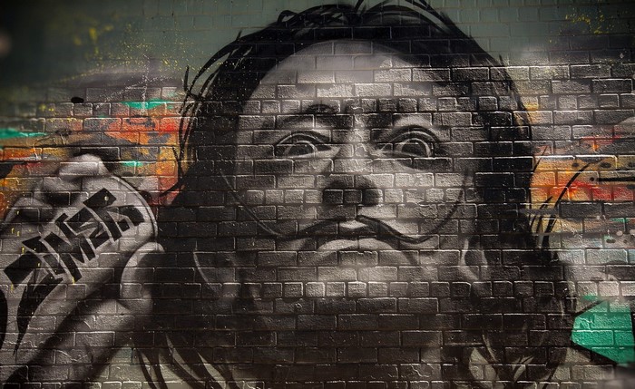 Graffiti portrait of Salvador Dali on a brick wall