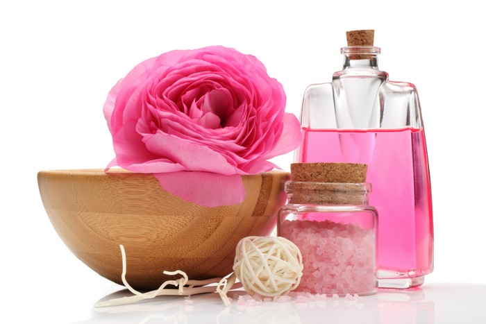 Pink rose, spa products, and wooden bowl