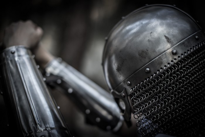 Close-up of a warrior in metal armor and helmet