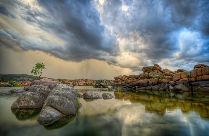 Stormy Sky Over Lake With Rocks and Tree
