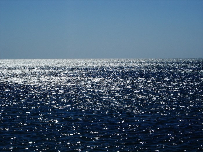 Ocean horizon with sunlit water