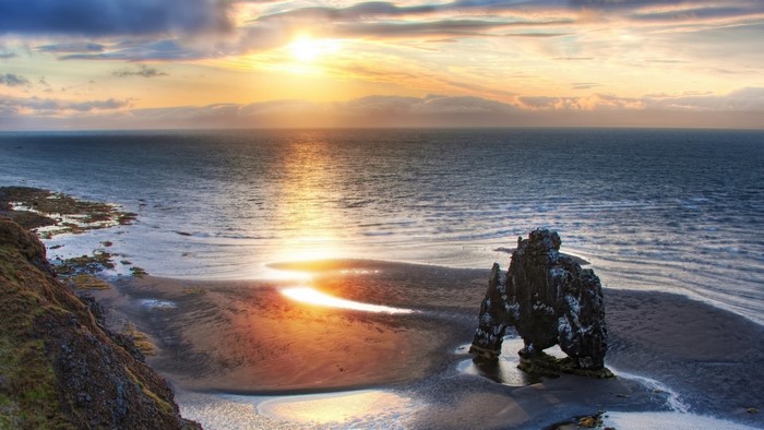 Sea coast with rock formation at sunset