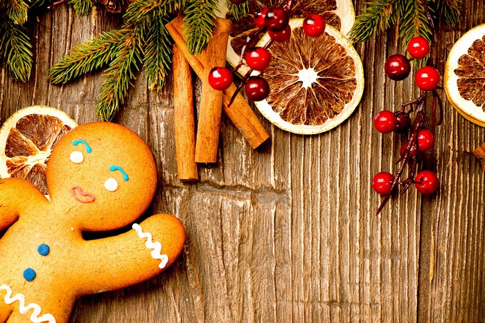 Christmas gingerbread man with cinnamon and dried oranges