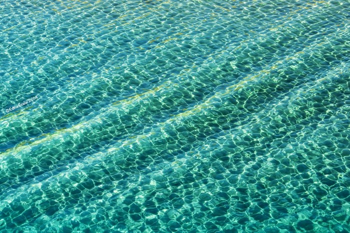 Rippling turquoise water with sunlight patterns