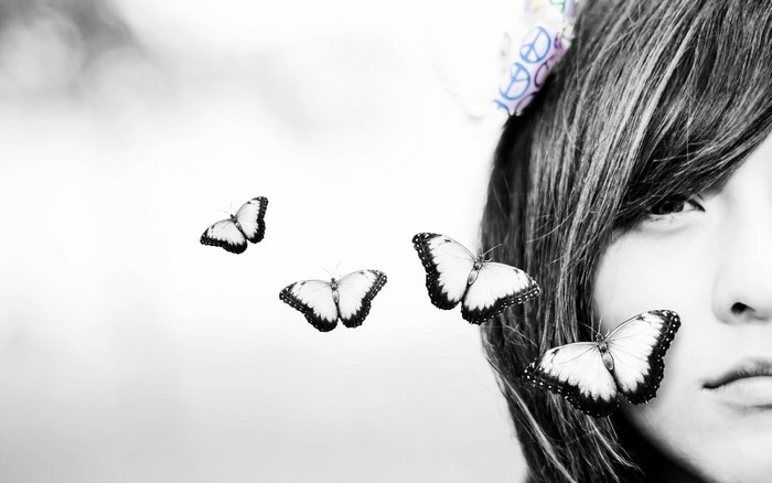 Black and white portrait of a girl with butterflies