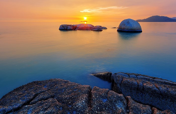Sunset over the sea with rocks