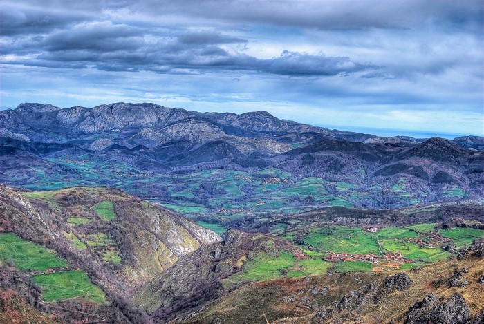 Mountain landscape with green valleys and cloudy sky