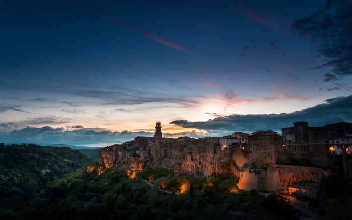 Pitigliano, Italy at dusk with illuminated buildings