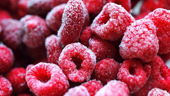 4K closeup of frozen raspberries