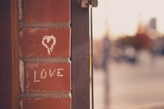 Heart and word LOVE drawn on a brick wall