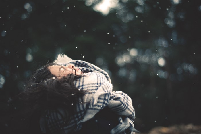 Girl in scarf with snow falling