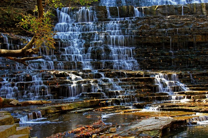 Tiered Waterfall Cascading Over Rocky Layers