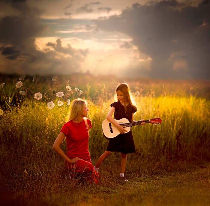 Woman and Girl with Guitar in Field
