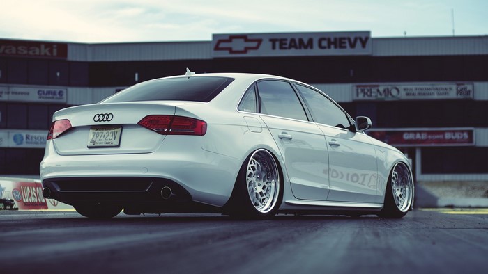 White Audi A4 sedan with custom wheels