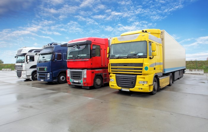 Four trucks parked in a lot